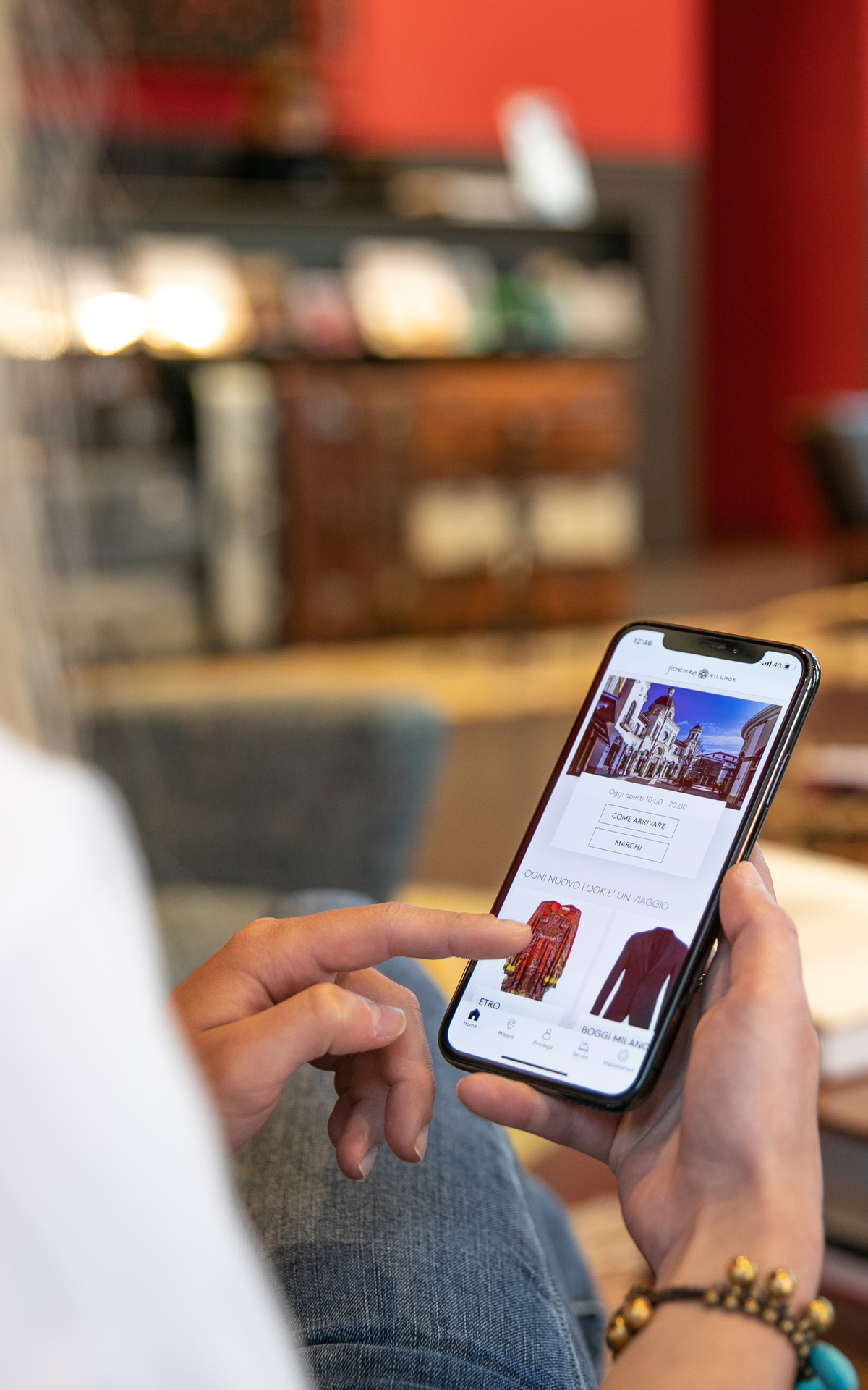 woman sitting on the sofa looking at the virtual mobile shopping