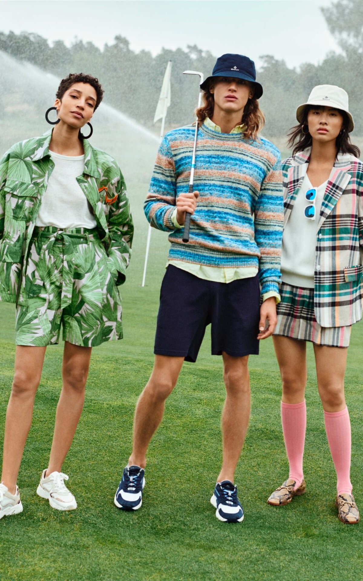 2 girls and a boy playing golf