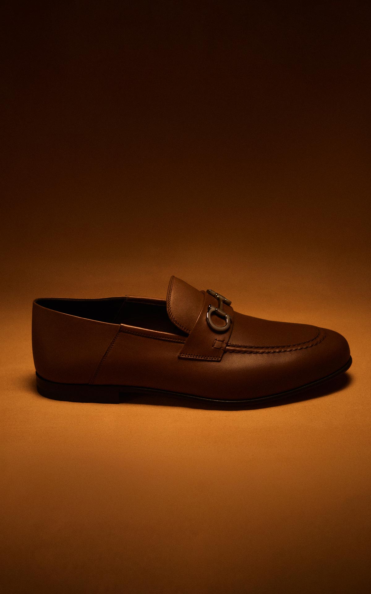 Salvatore Ferragamo men's brown leather loafers with Gancini detail as part of The Amber Room editorial at Bicester Village.