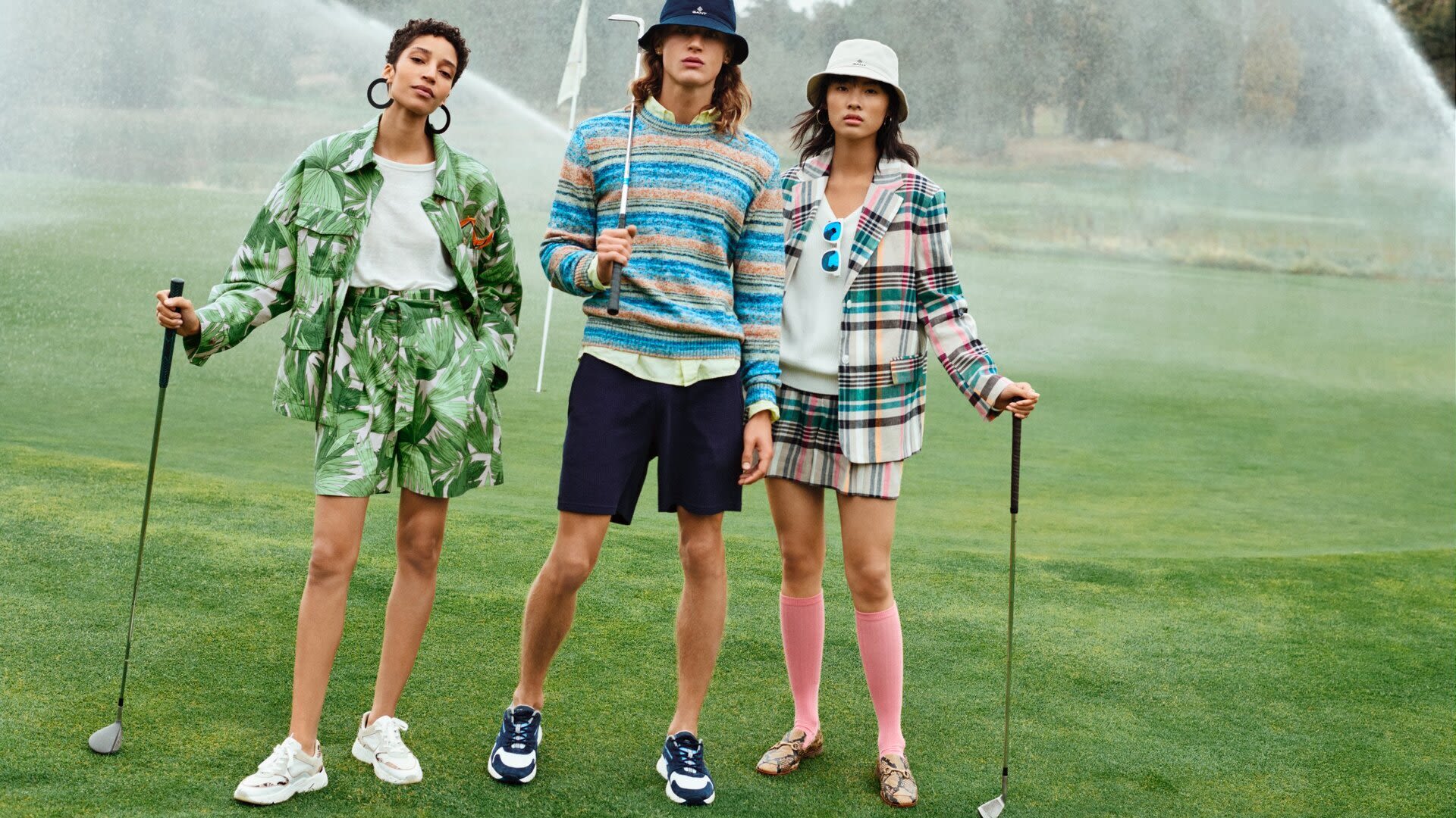 2 girls and a boy playing golf