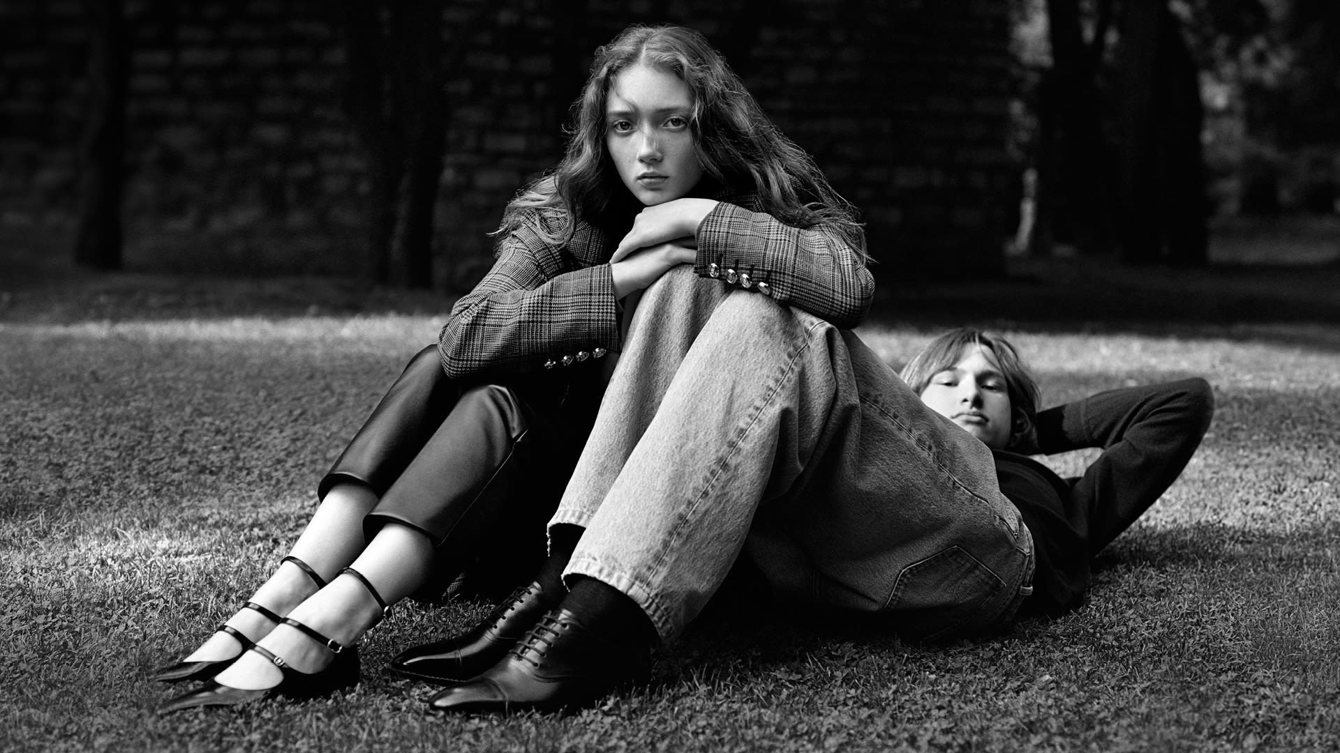 Man and woman in the countryside with Bally jackets and bags