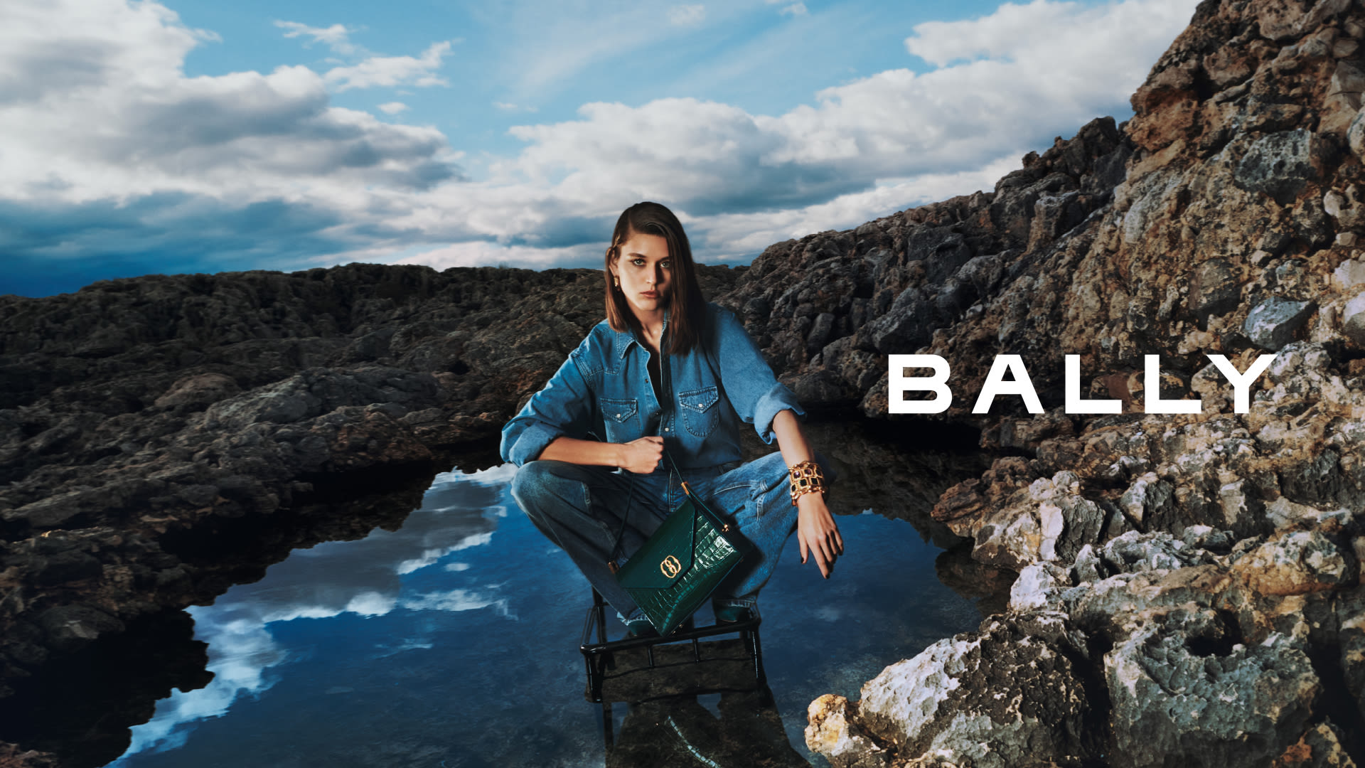 Man and woman in the countryside with Bally jackets and bags